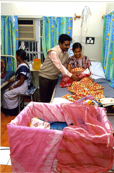 Indian family celebrating the birth of their baby in a hospital 
